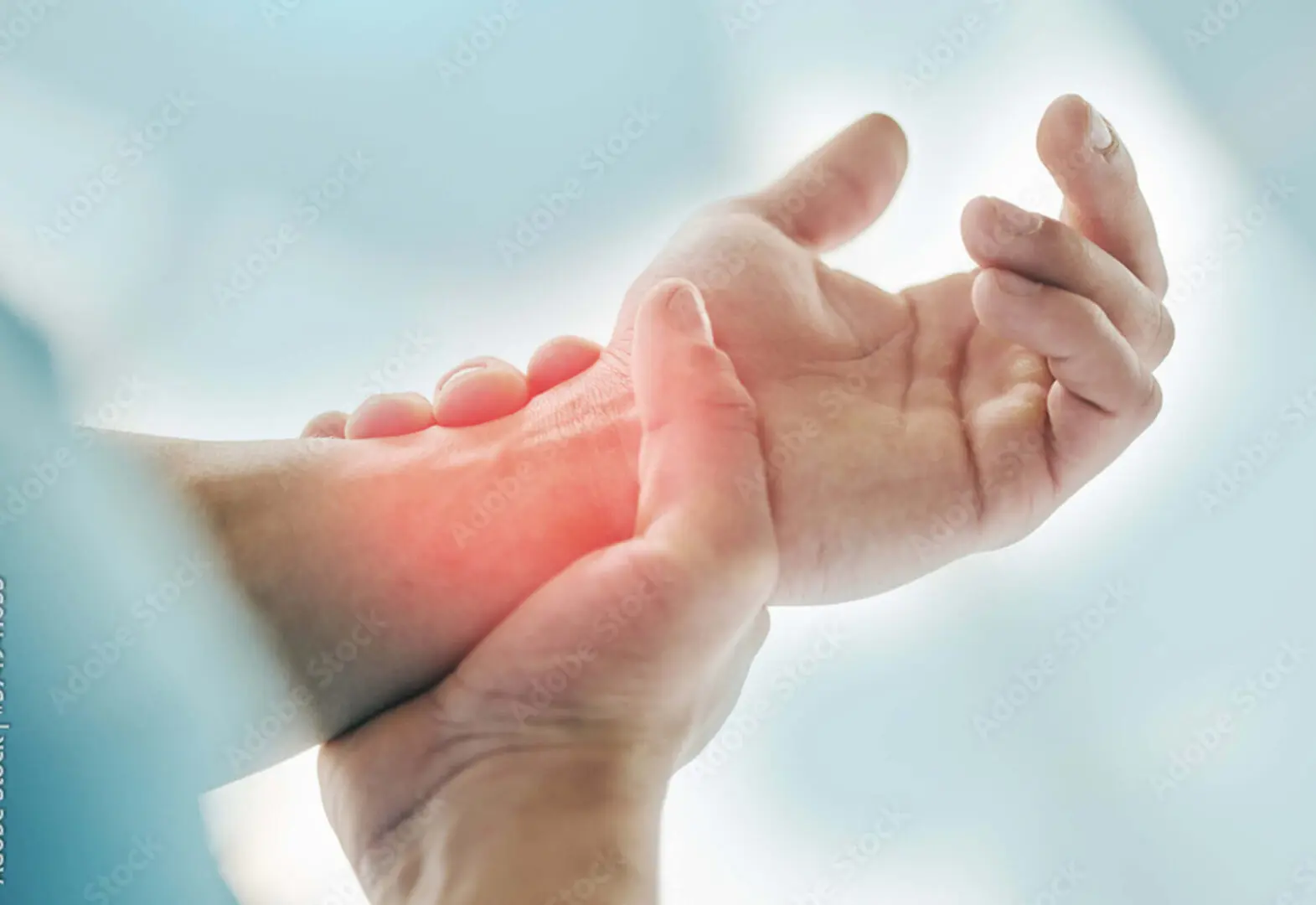 A person gently holds their wrist, emphasizing an area of red inflammation or discomfort, possibly finding relief through the calming touch of bioenergy healing.