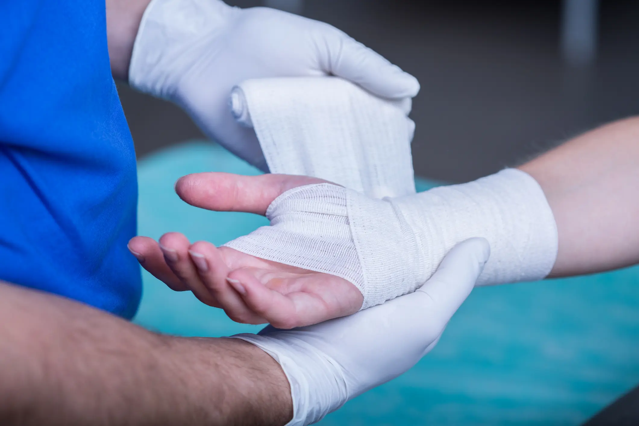 A person with white bandages on their hands.